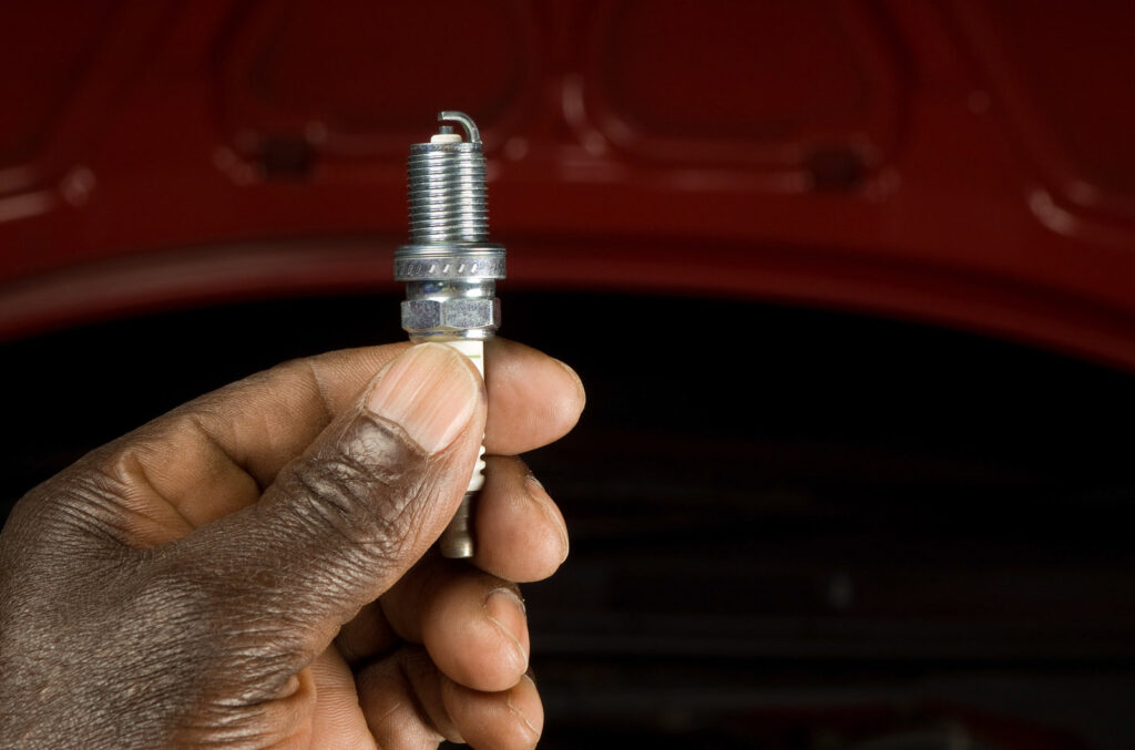 A mechanic holding a spark plug