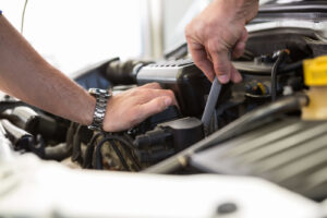 A mechanic working on a automobile engine