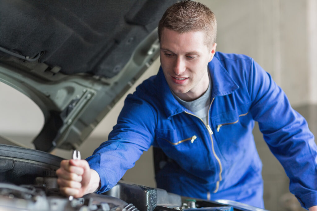 a Mechanic Working on the Engine of an Automobile A mechanic working on the engine of an automobile