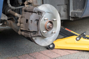 New disk brakes and calipers being installed on a car