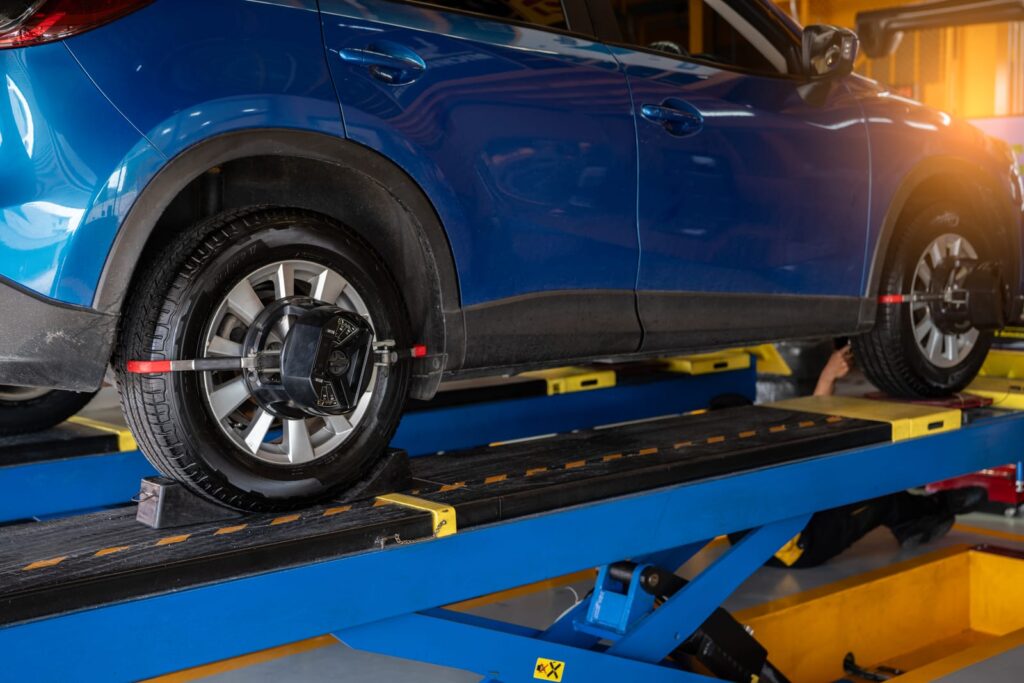 Wheel alignment equipment being used to align the wheels on a car