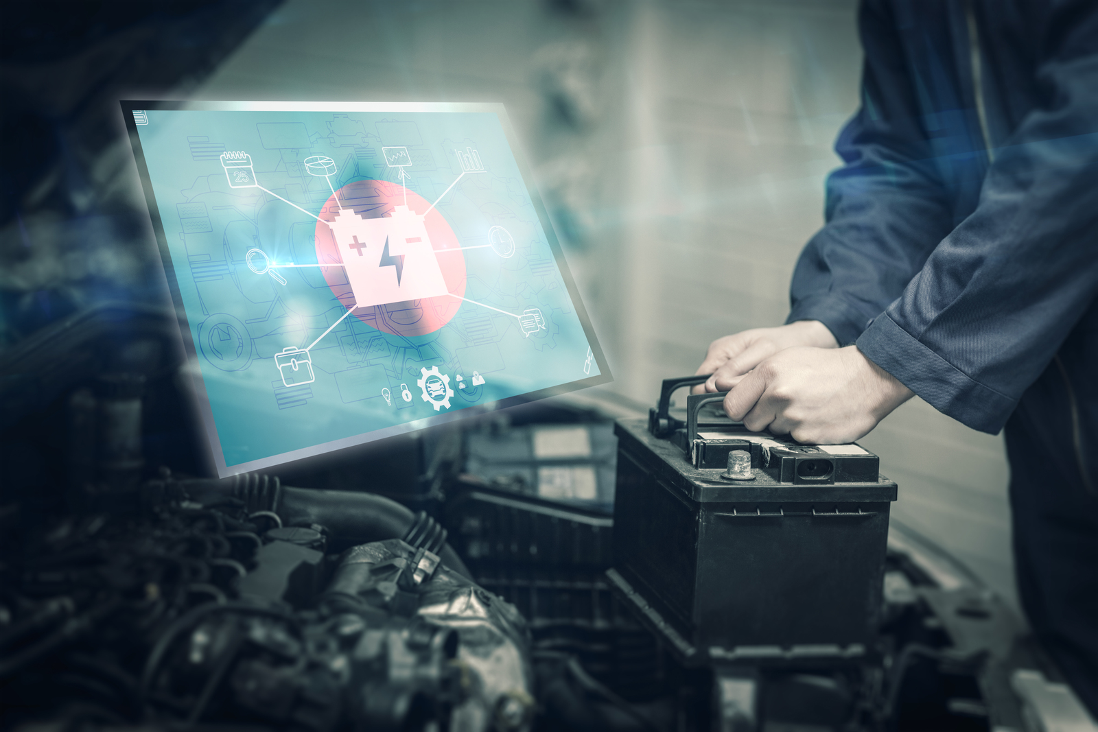 Automotive repair technician installing a battery