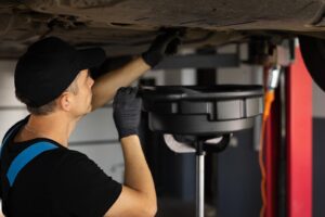 a Mechanic Drain the Old Oil from the Engine Through the Drain Plug Changing the Oil in a Car Engine Car Engine Oil Replacement Car Maintenance Car Mechanic Replaces the Oil in the Engine A mechanic drain the old oil from the engine through the drain plug Changing the oil in a car engine Car engine oil replacement Car maintenance car mechanic replaces the oil in the engine