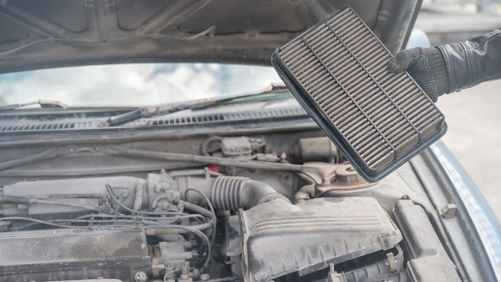 A Mechanic Changing a Dirty Air Filter