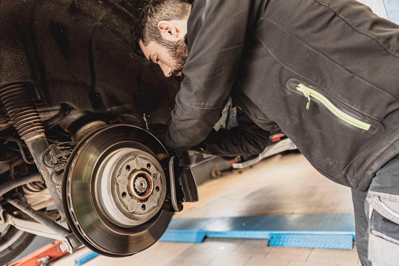 A Mechanic Working on Brakes