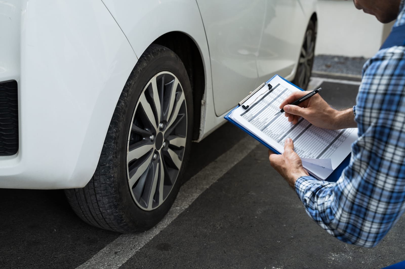 A mechanic inspecting a vehicles tires