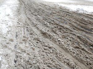 Snow and dirt on the road. Uncleared city roads in winter