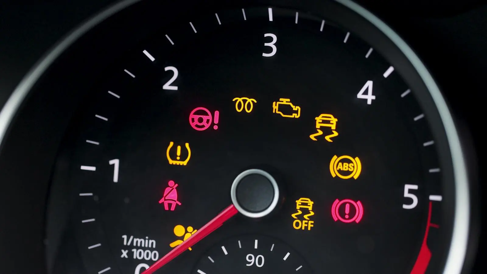 Many different car dashboard lights with warning lamps illuminated