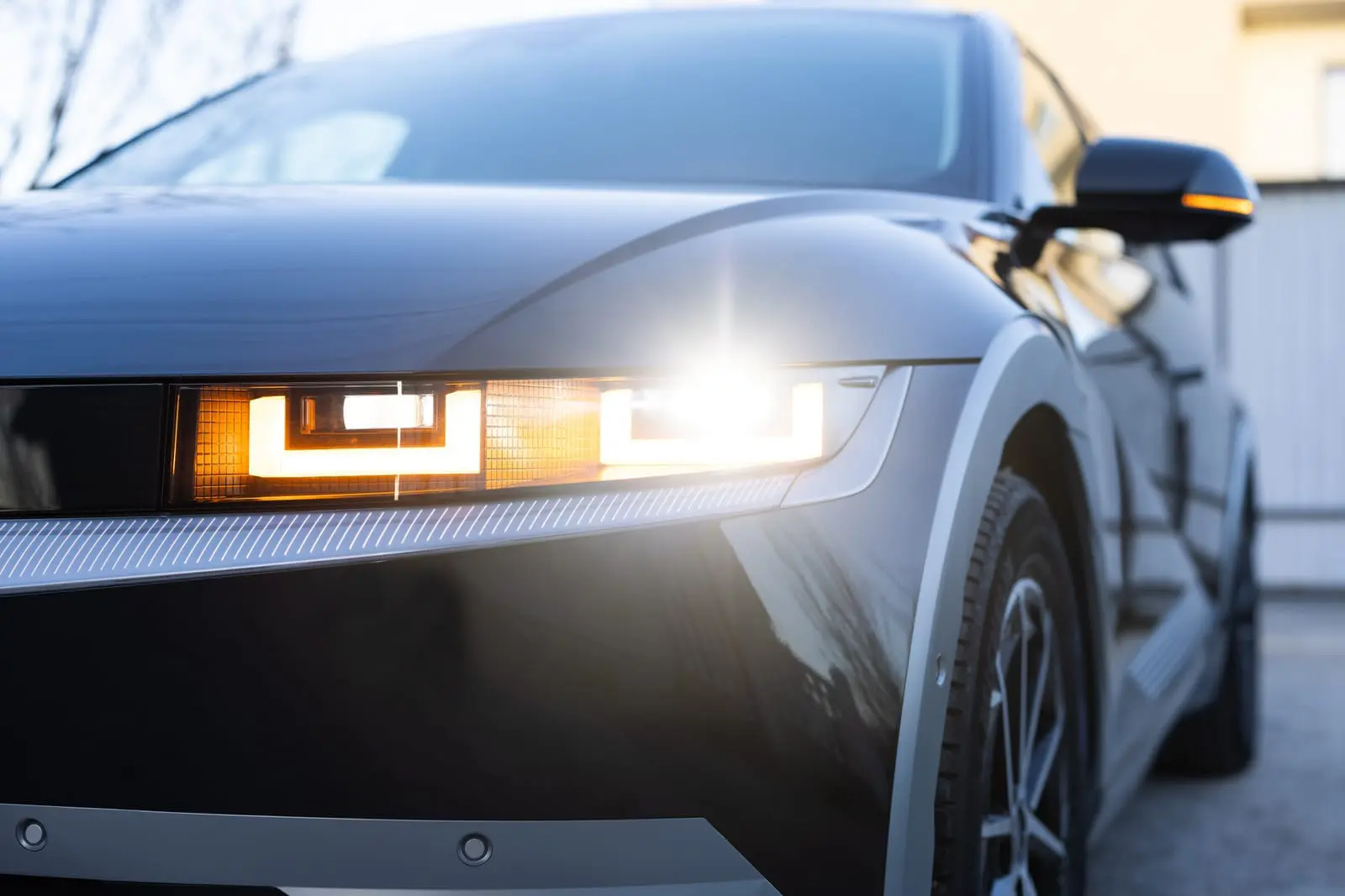 The modern headlights or front light of the automobile car in the capital city.