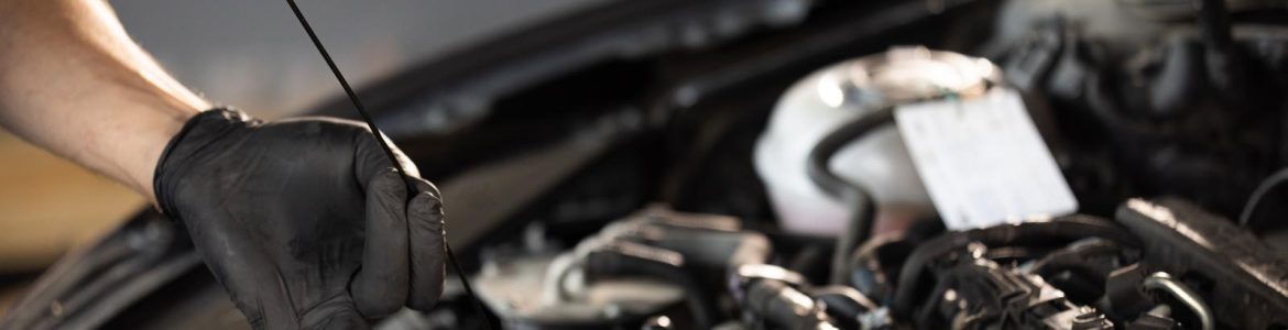 A mechanic checking the engine oil