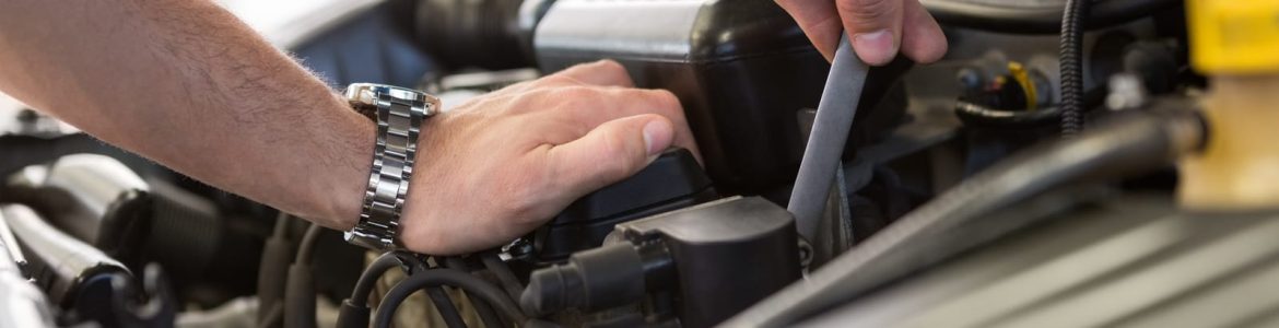 A mechanic working on a automobile engine
