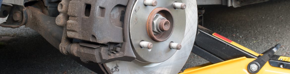 New disk brakes and calipers being installed on a car