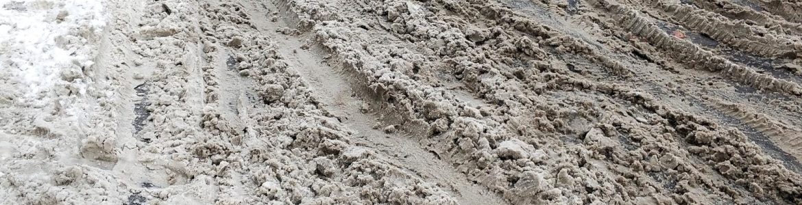 Snow and dirt on the road. Uncleared city roads in winter
